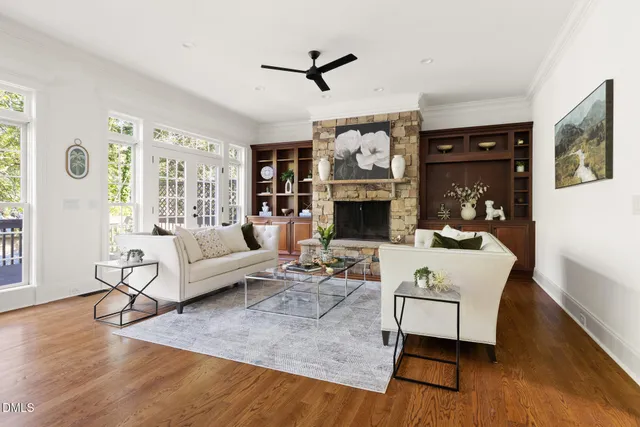a living room with furniture fireplace and a window