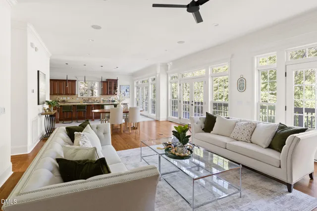 a living room with furniture and a view of kitchen