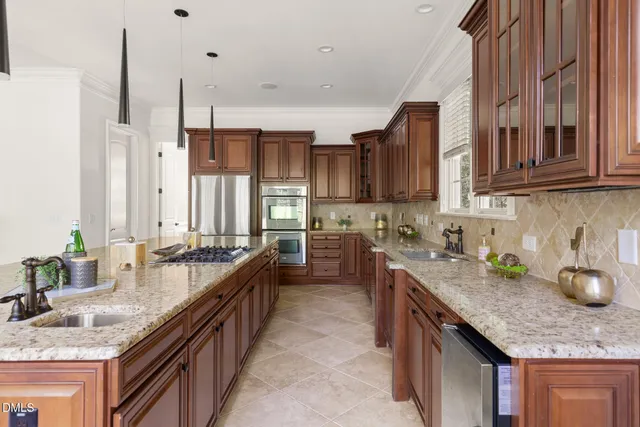 a kitchen with granite countertop a sink and a stove