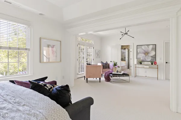 a bedroom with furniture and a large window