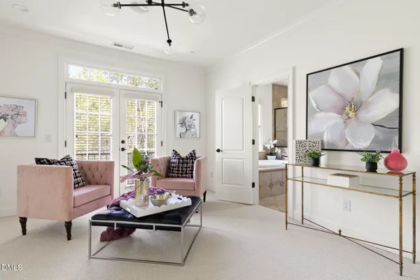 a living room with furniture a flat screen tv and a table