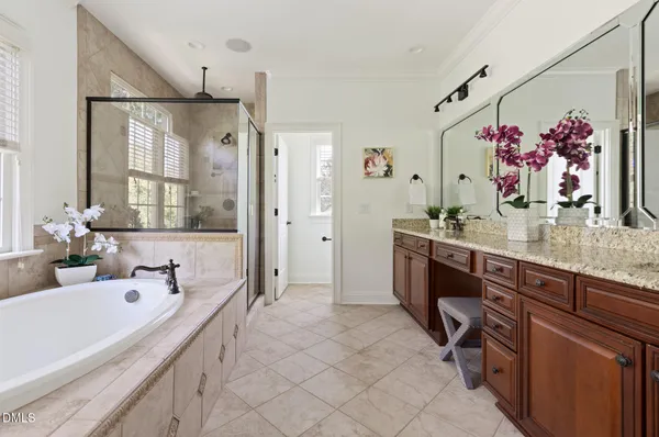 a bathroom with a tub sink and mirror