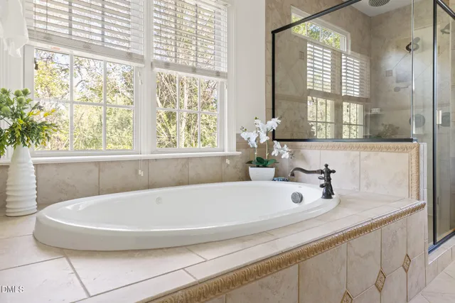 a bathroom with a tub and large window