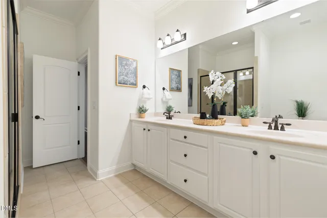 a bathroom with a double vanity sink mirror and