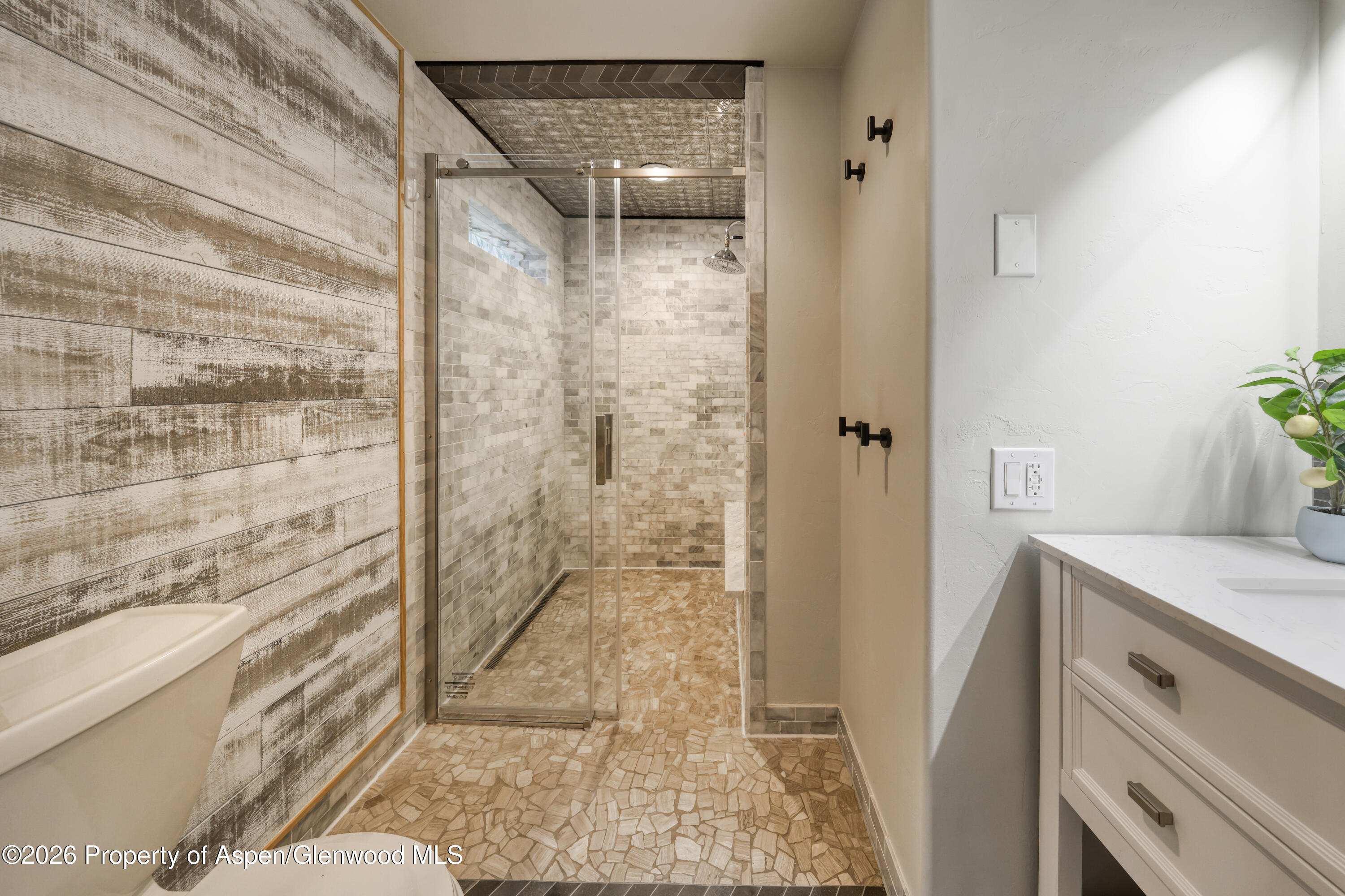 113 West State Street Marble, CO 81623 - Photo 14 of 44 a bathroom with a granite countertop shower and a sink