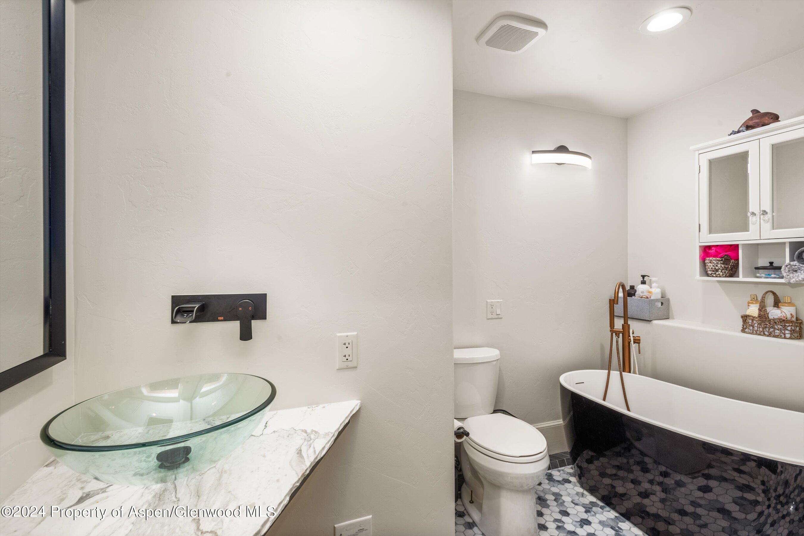 113 West State Street Marble, CO 81623 - Photo 17 of 44 a bathroom with a toilet a sink and a mirror