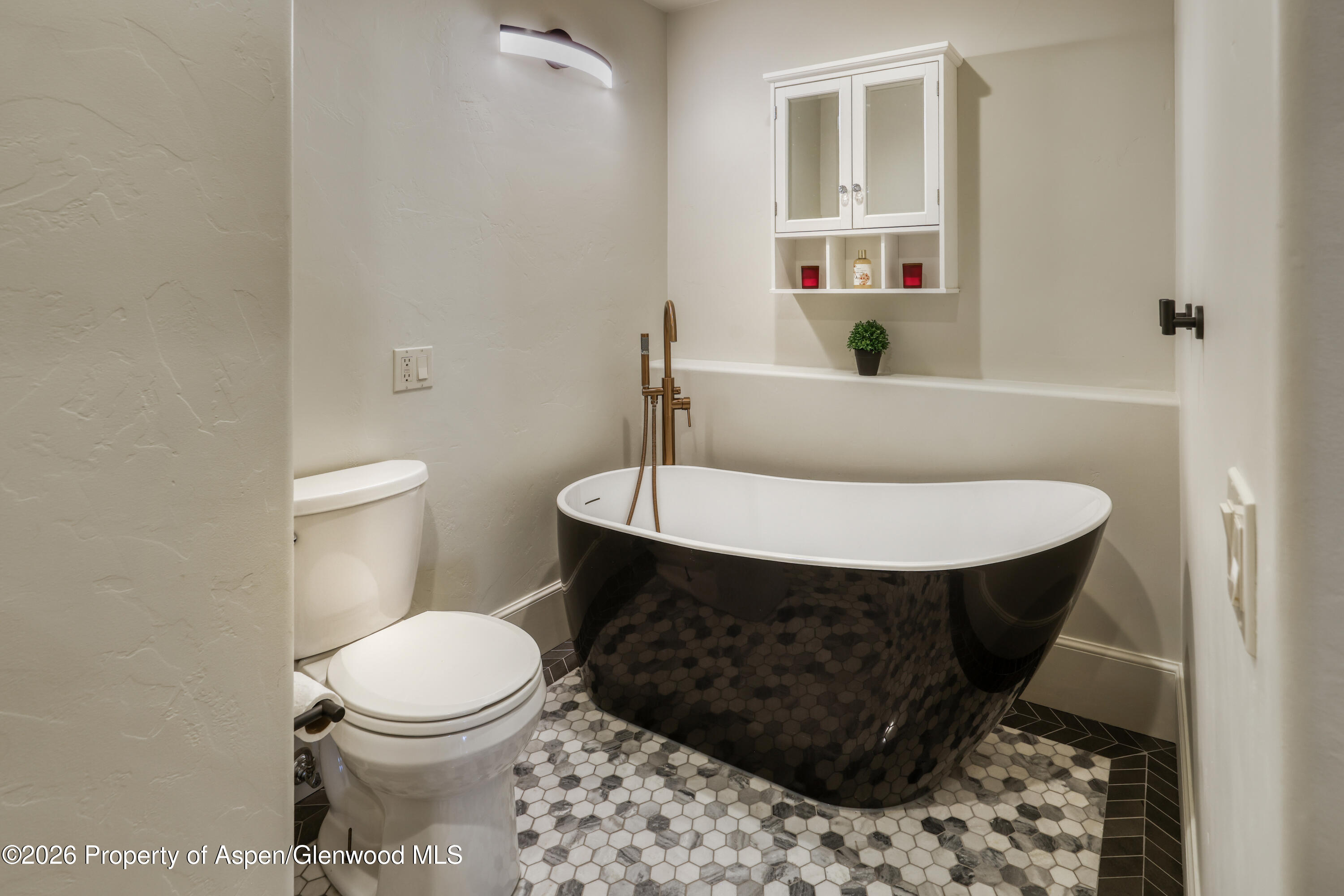 113 West State Street Marble, CO 81623 - Photo 18 of 44 a bathroom with a toilet a sink and a mirror