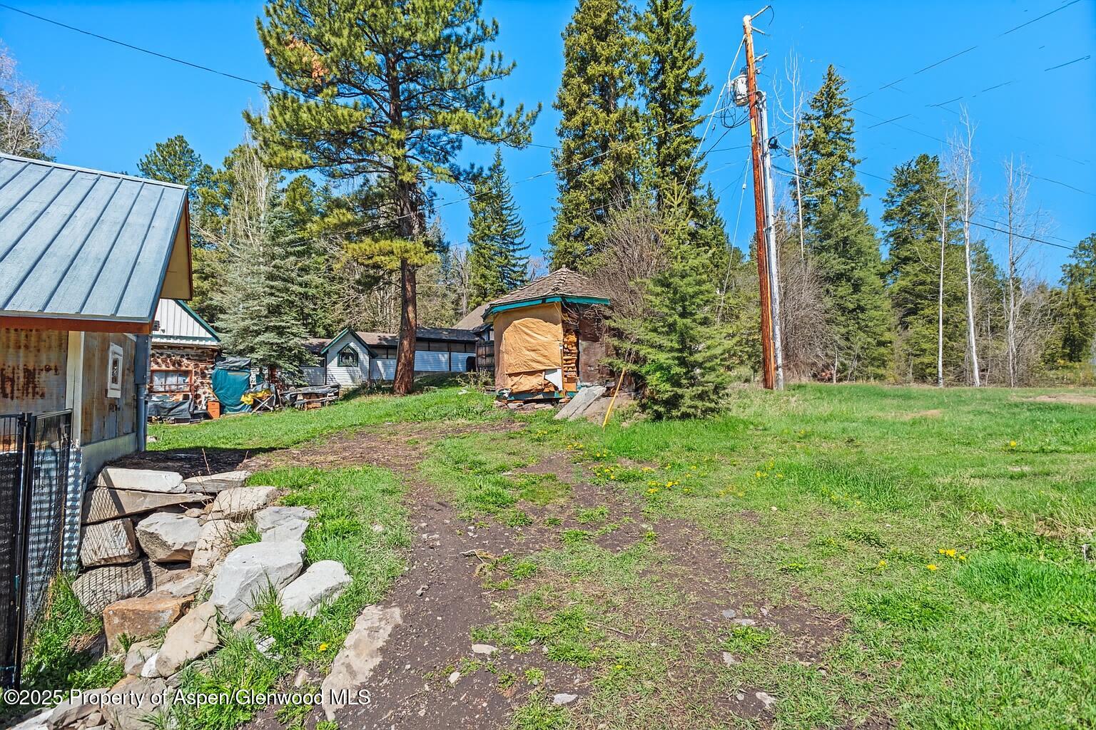 113 West State Street Marble, CO 81623 - Photo 29 of 44 a view of a garden with a house