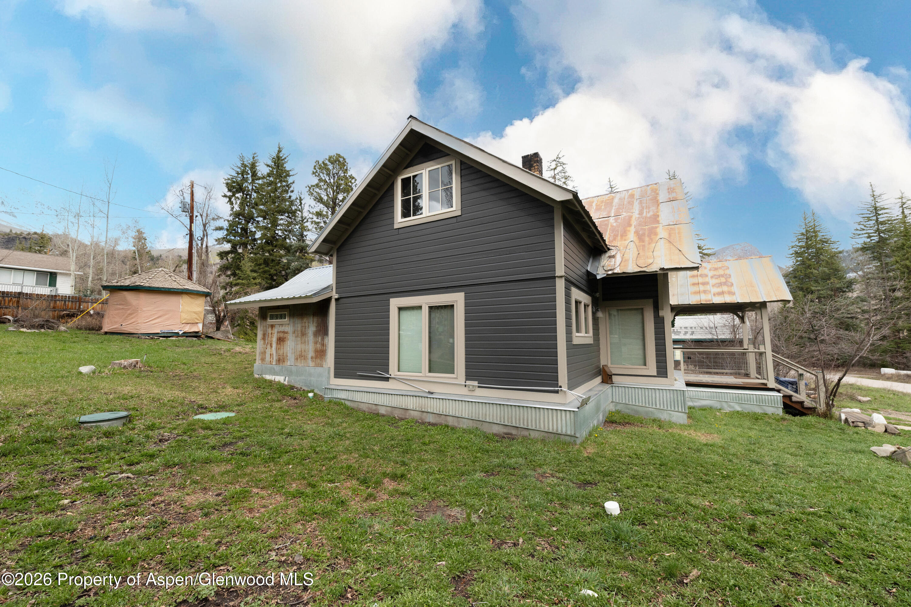 113 West State Street Marble, CO 81623 - Photo 32 of 44 a front view of a house with a yard