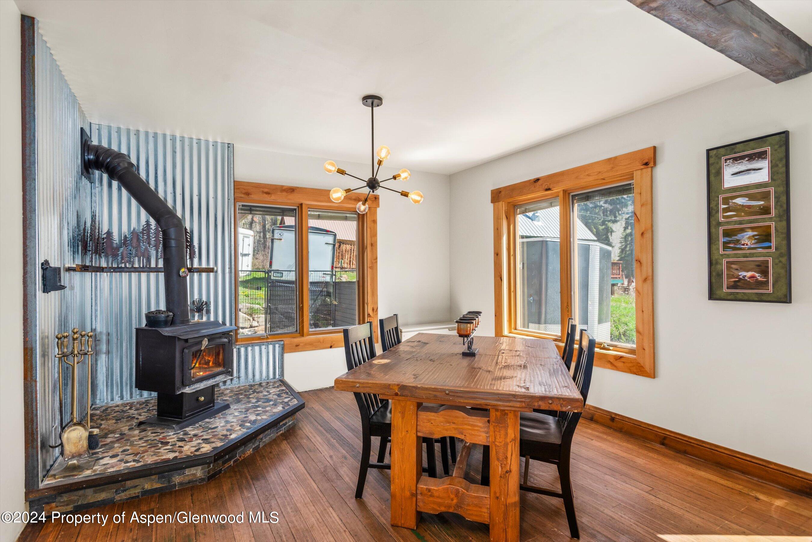 113 West State Street Marble, CO 81623 - Photo 4 of 44 a dining room with furniture a chandelier and wooden floor
