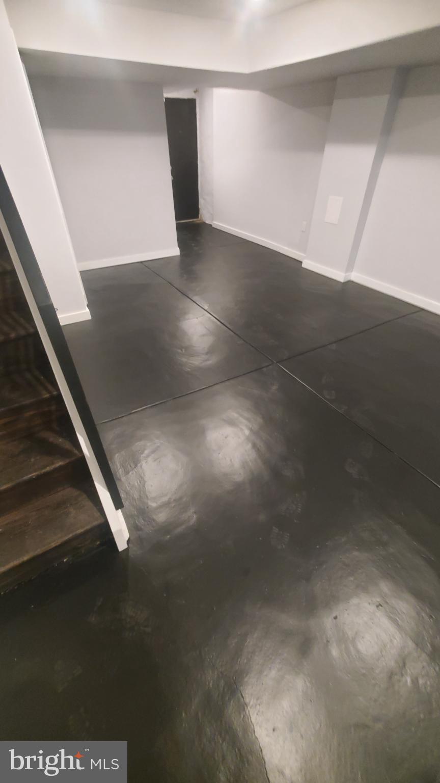 7311 North 21st Street Philadelphia, PA 19138 - Photo 11 of 15 Spacious, modern basement with sleek flooring.