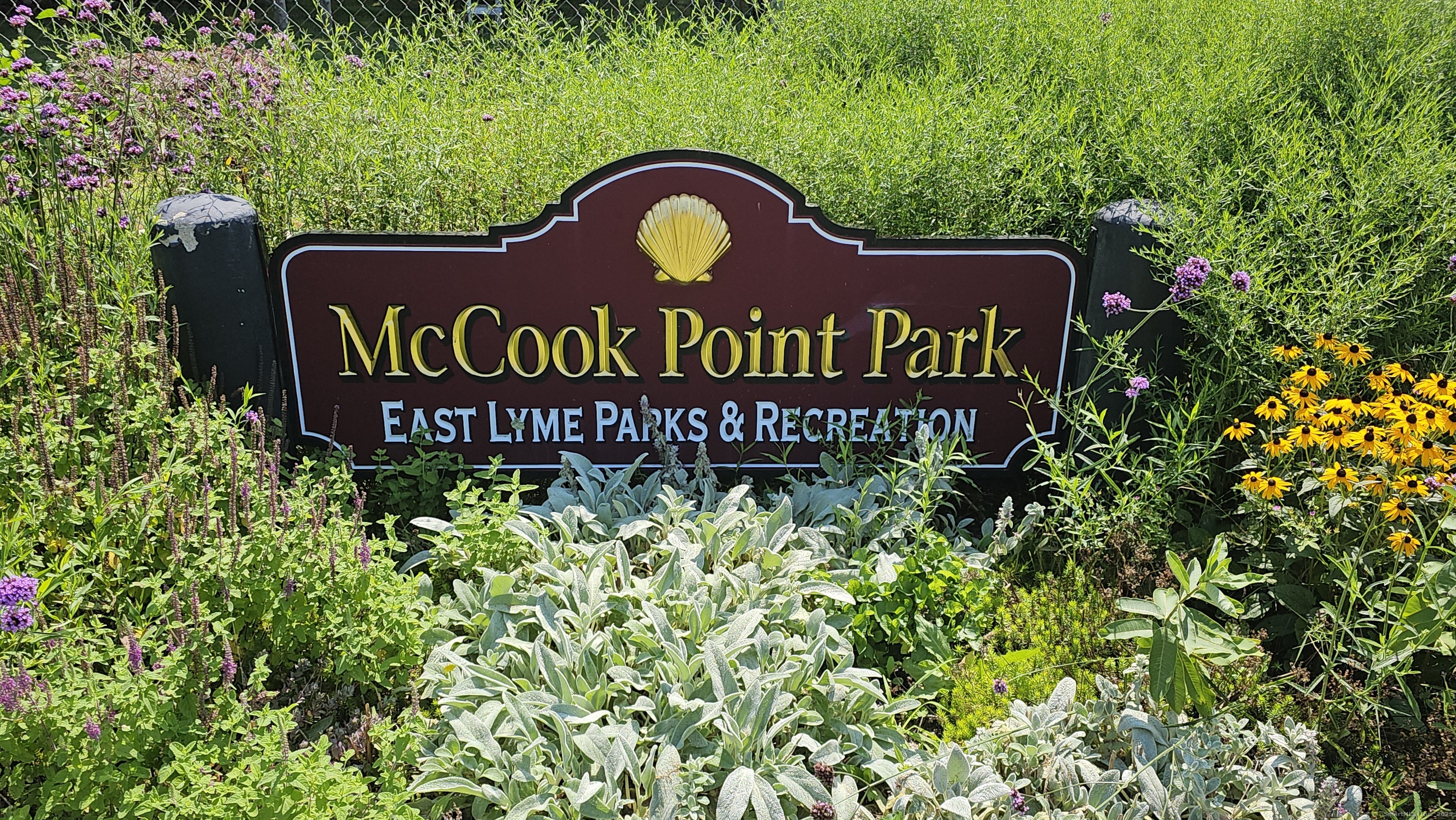 127 Black Point Road, Unit 7 East Lyme, CT 06357 - Photo 15 of 15 a view of a sign in a garden