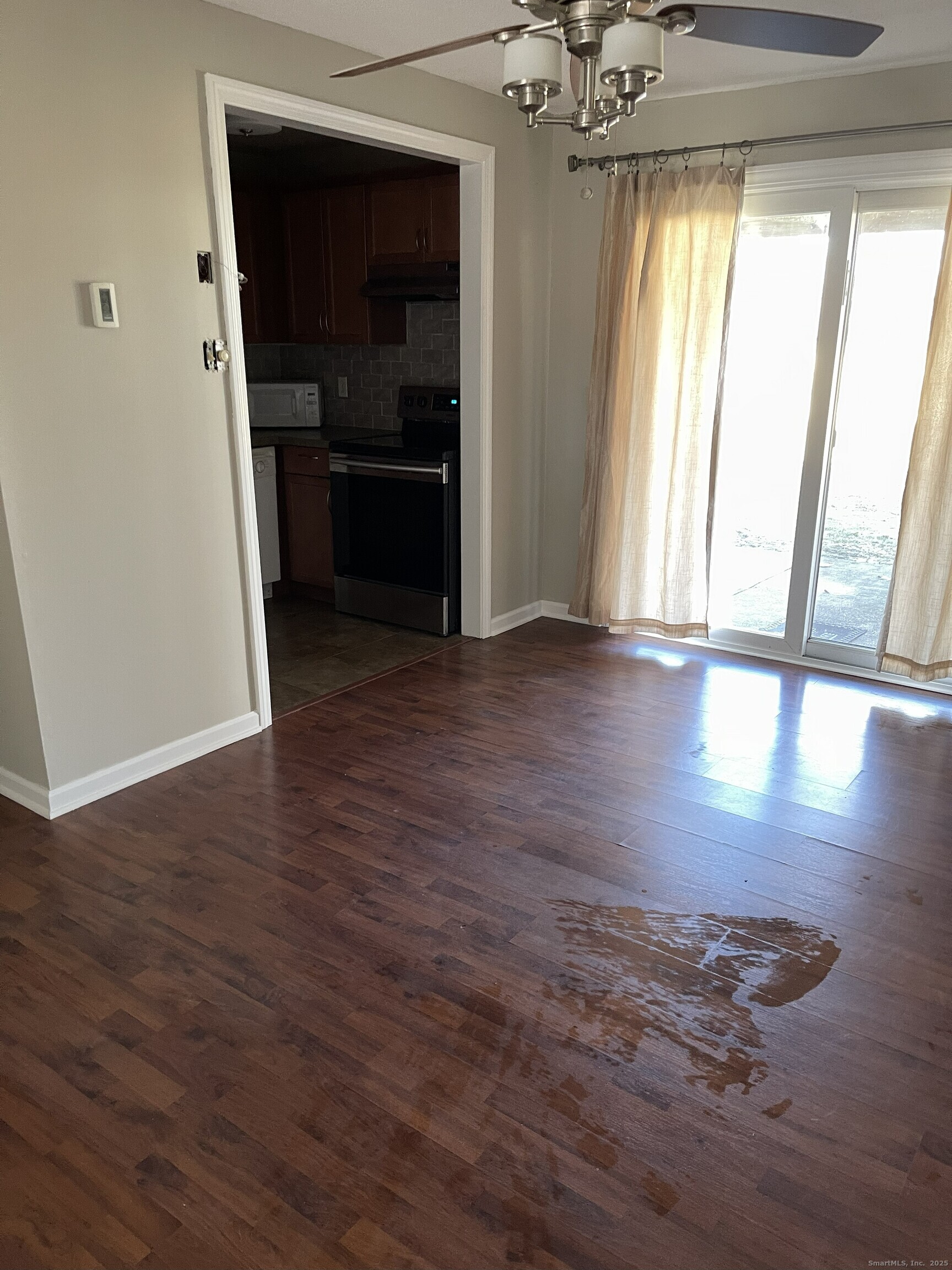 127 Black Point Road, Unit 7 East Lyme, CT 06357 - Photo 6 of 15 wooden floor in an empty room with a window