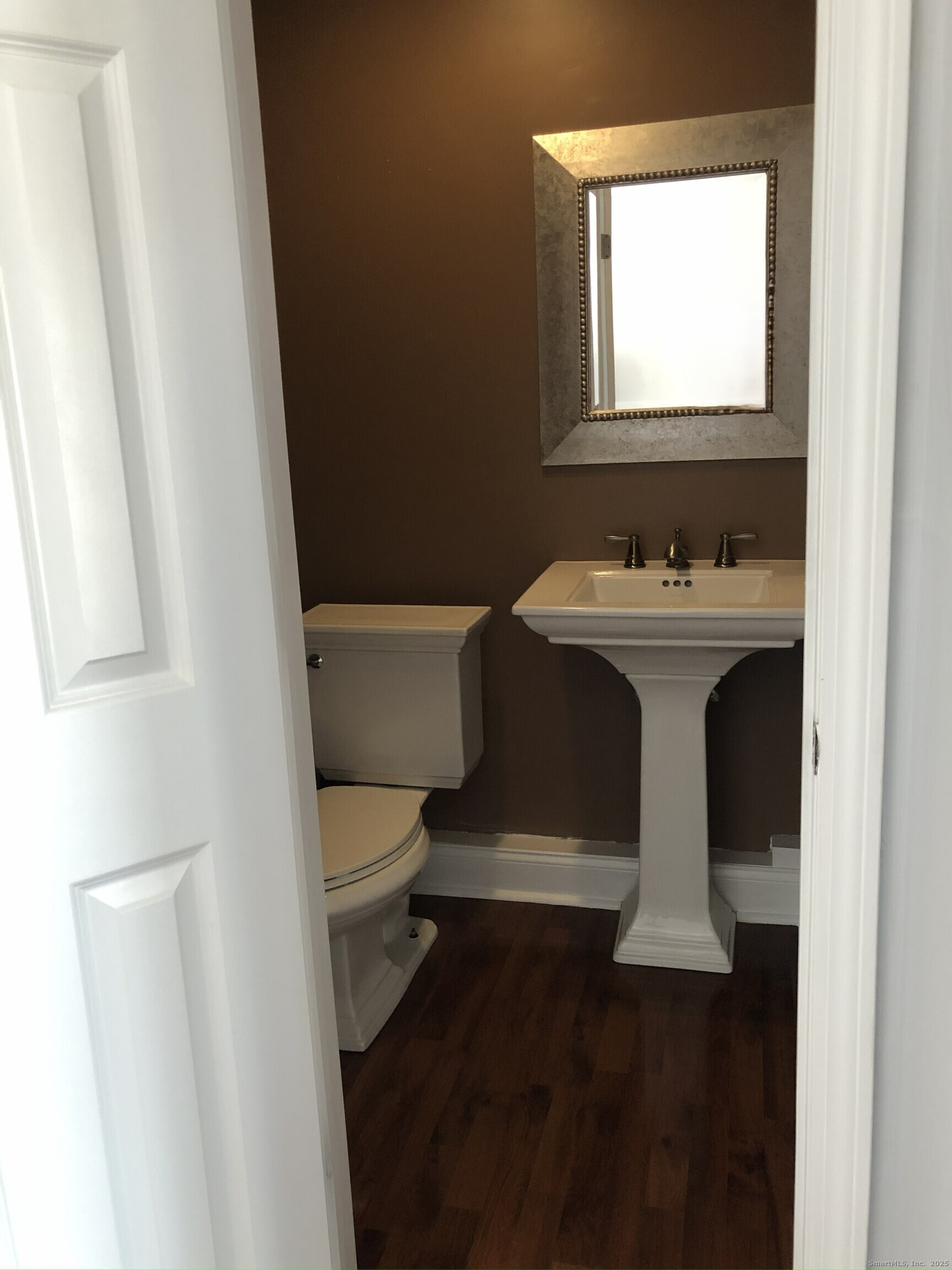 127 Black Point Road, Unit 7 East Lyme, CT 06357 - Photo 10 of 15 a white toilet sitting next to a bathroom sink