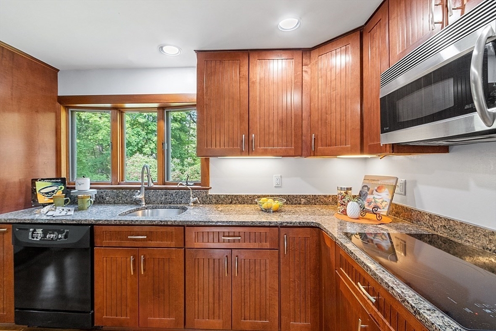 130 Adams Road Concord, MA 01742 - Photo 11 of 33 a kitchen with stainless steel appliances granite countertop a sink stove and cabinets