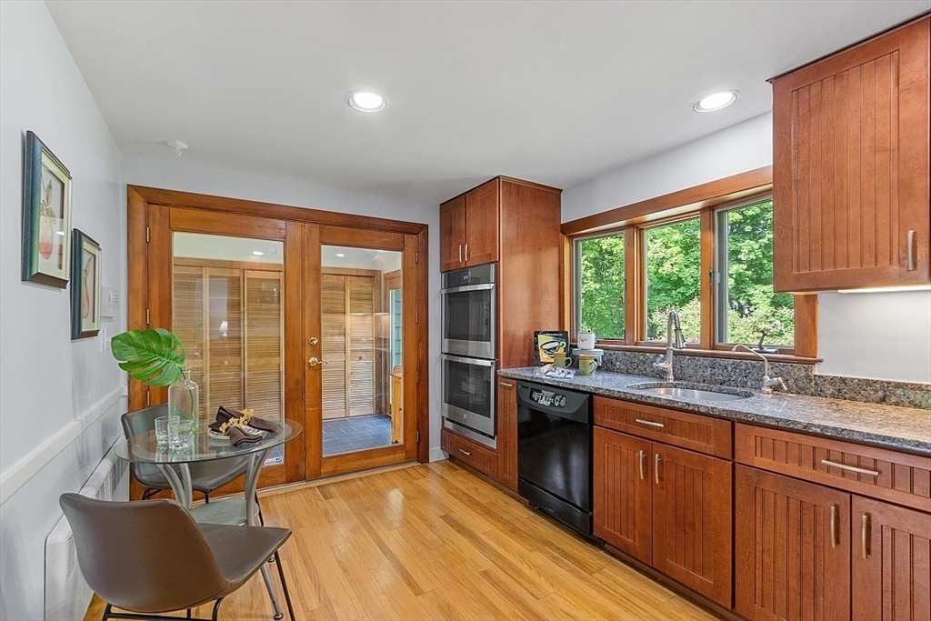 130 Adams Road Concord, MA 01742 - Photo 12 of 33 a kitchen with stainless steel appliances granite countertop sink stove and wooden cabinets