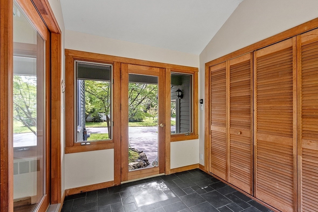 130 Adams Road Concord, MA 01742 - Photo 14 of 33 a view of an empty room with wooden floor and windows