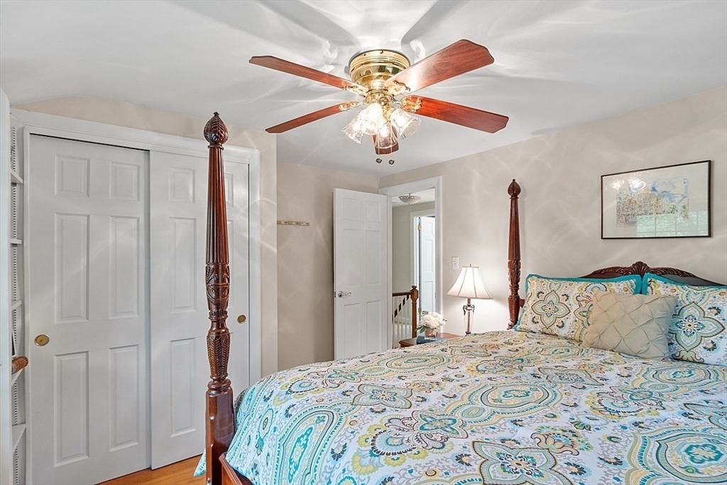 130 Adams Road Concord, MA 01742 - Photo 19 of 33 a bedroom with a bed and a chandelier