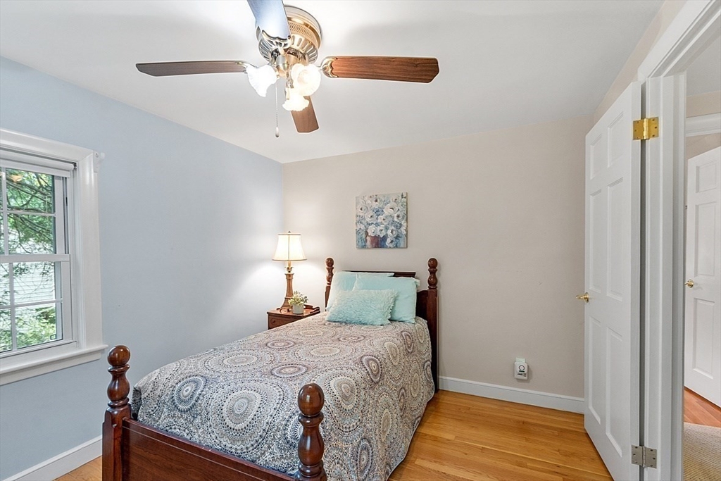 130 Adams Road Concord, MA 01742 - Photo 20 of 33 a bedroom with a bed and a chandelier
