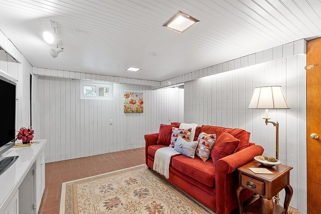130 Adams Road Concord, MA 01742 - Photo 24 of 33 a living room with furniture a flat screen tv and a lamp