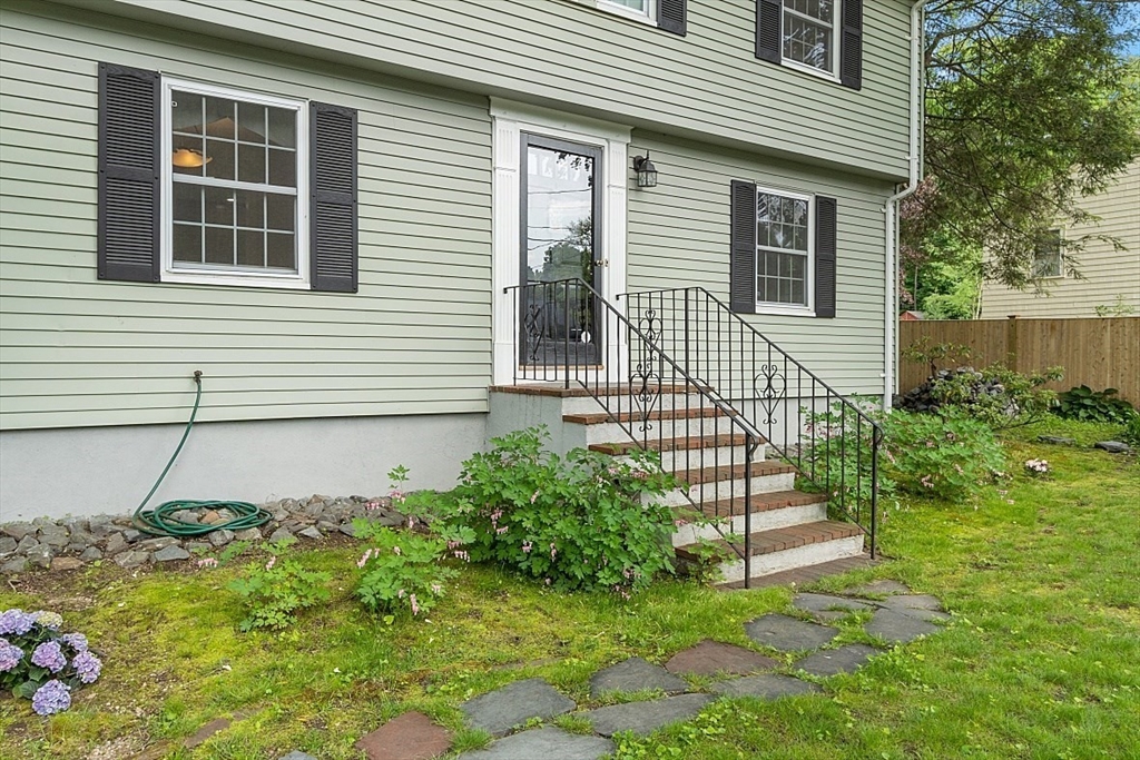 130 Adams Road Concord, MA 01742 - Photo 4 of 33 a view of a house with a small yard and wooden fence