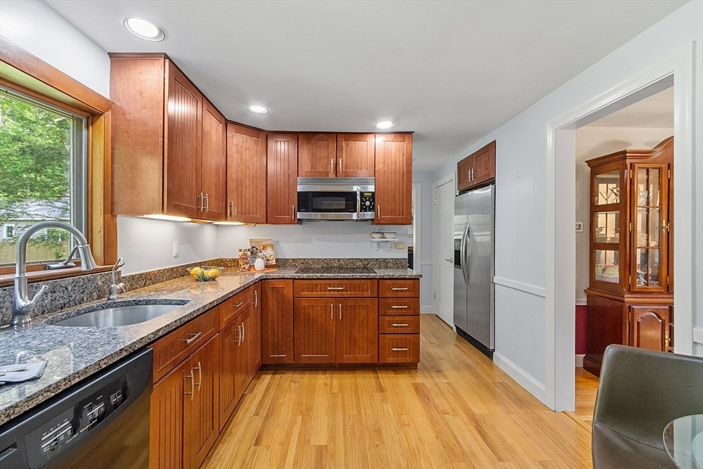 130 Adams Road Concord, MA 01742 - Photo 10 of 33 a kitchen with stainless steel appliances granite countertop wooden cabinets a stove top oven a sink and dishwasher