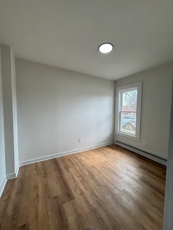 a view of wooden floor and windows in a room