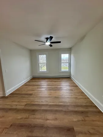 a view of an empty room with a ceiling fan