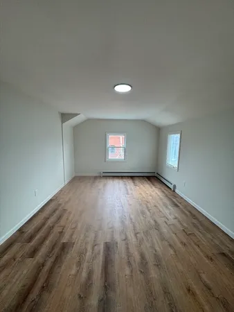 a view of empty room with wooden ceiling