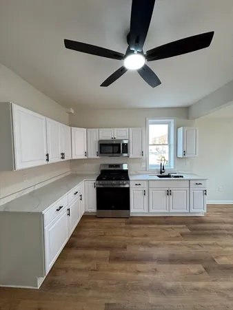 a bathroom with a tub sink a mirror and a shower