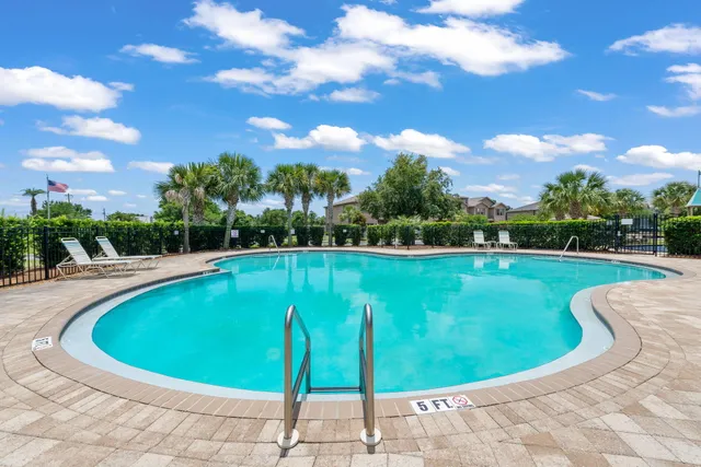 a view of a swimming pool with a yard