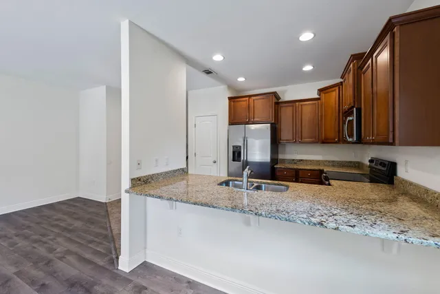 a view of kitchen with sink and microwave