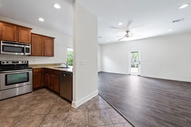 a kitchen with stainless steel appliances granite countertop a refrigerator and a sink