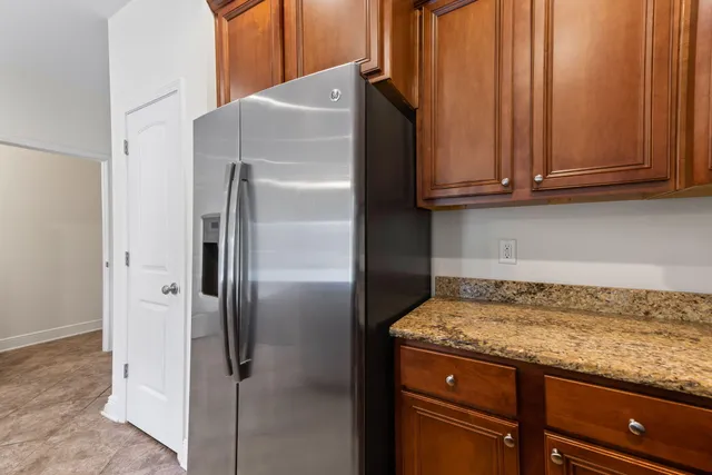 a kitchen with stainless steel appliances granite countertop a refrigerator stove and microwave