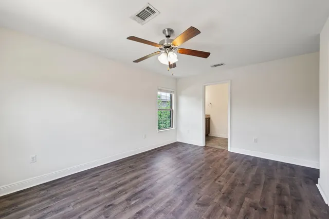 a bathroom with a granite countertop sink a large mirror and a shower