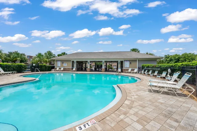 a view of a house with swimming pool and sitting area