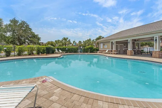 a living room with patio furniture and a large window