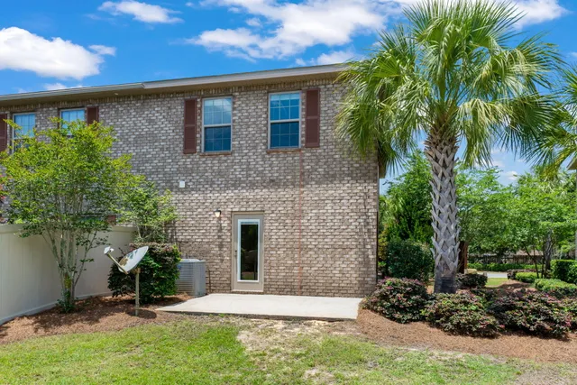 a view of a hallway with wooden floor and a mirror