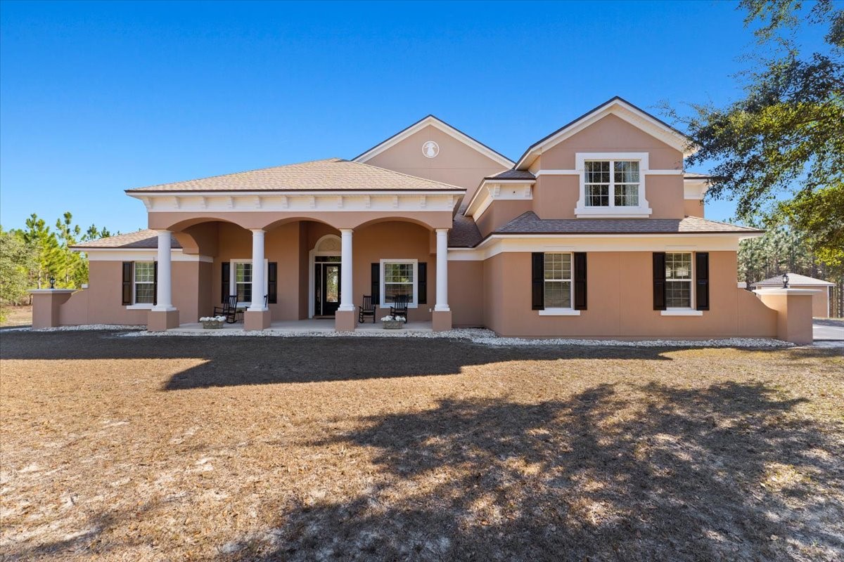 27247 Hallman Road Hilliard, FL 32046 - Photo 5 of 59 a front view of a house with a yard