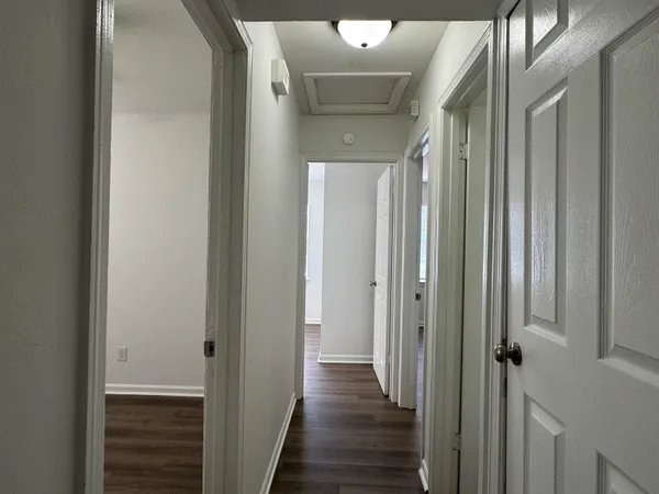 a view of a hallway with wooden floor