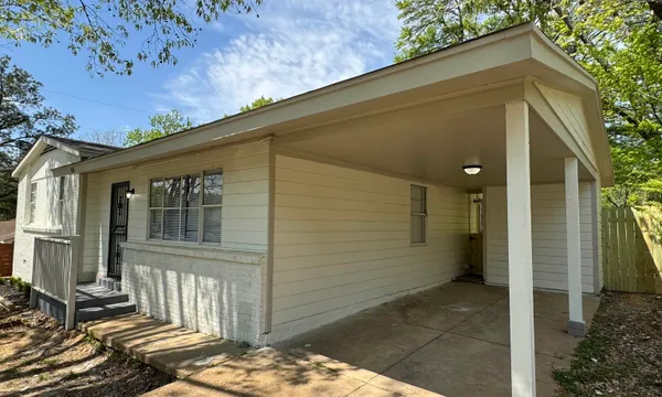 a view of a house with a small backyard