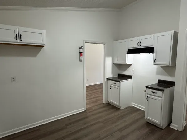 a kitchen with a refrigerator sink and stove top oven