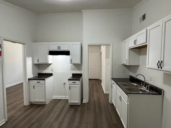 a kitchen with stainless steel appliances a sink stove and refrigerator