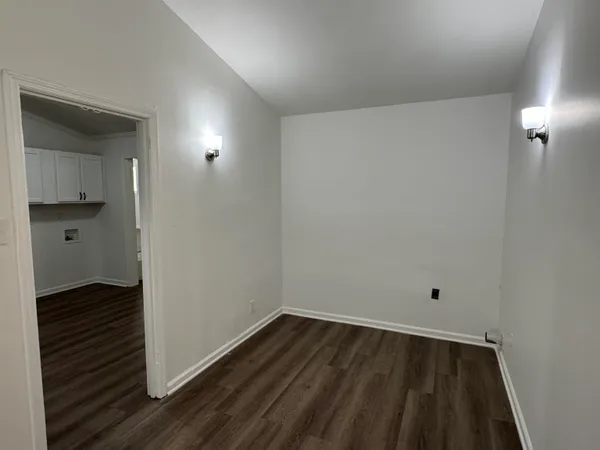 a view of an empty room and wooden floor