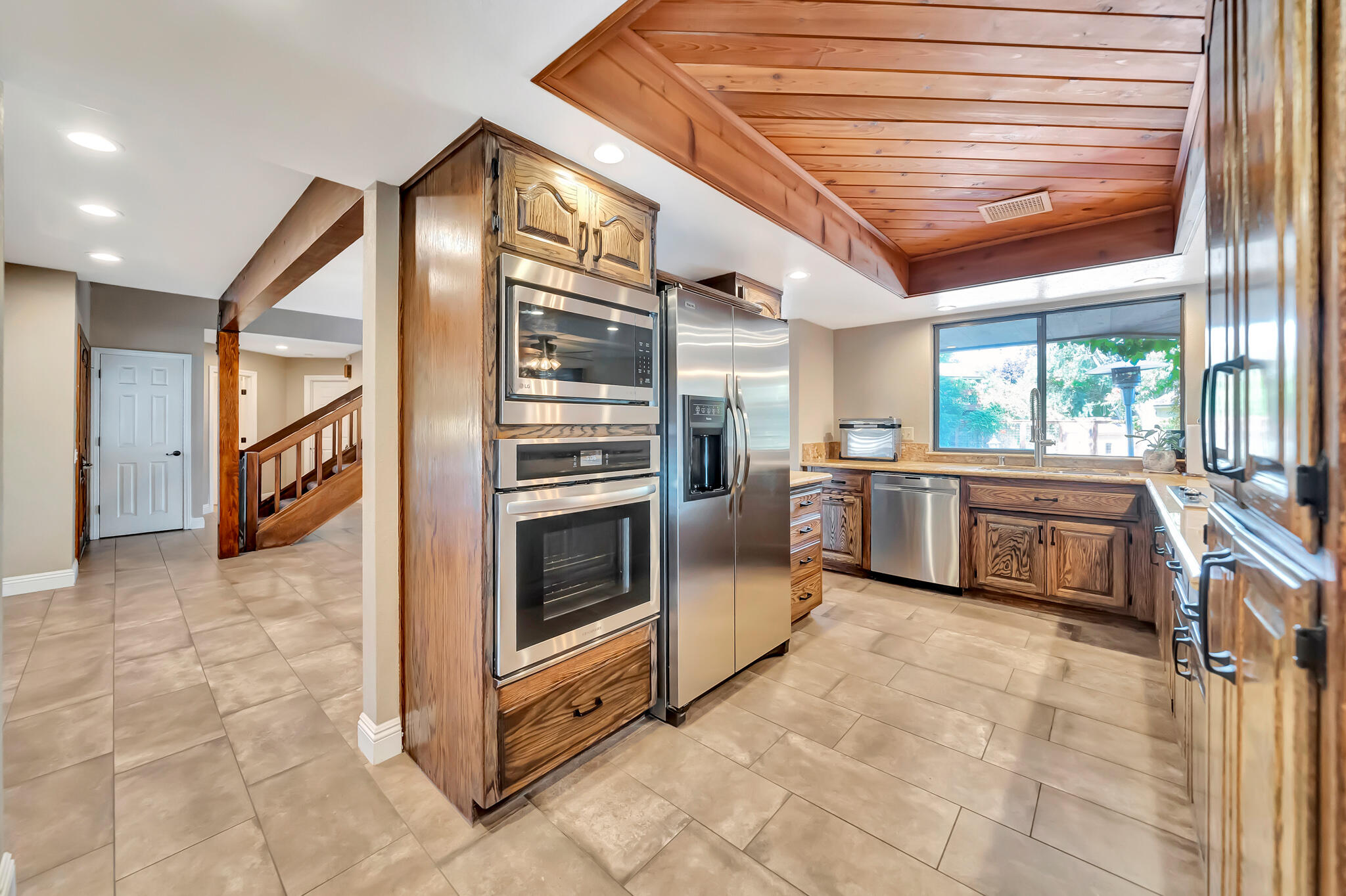 39844 Golfers Drive Palmdale, CA 93551 - Photo 22 of 87 a kitchen with stainless steel appliances a stove a sink and a refrigerator