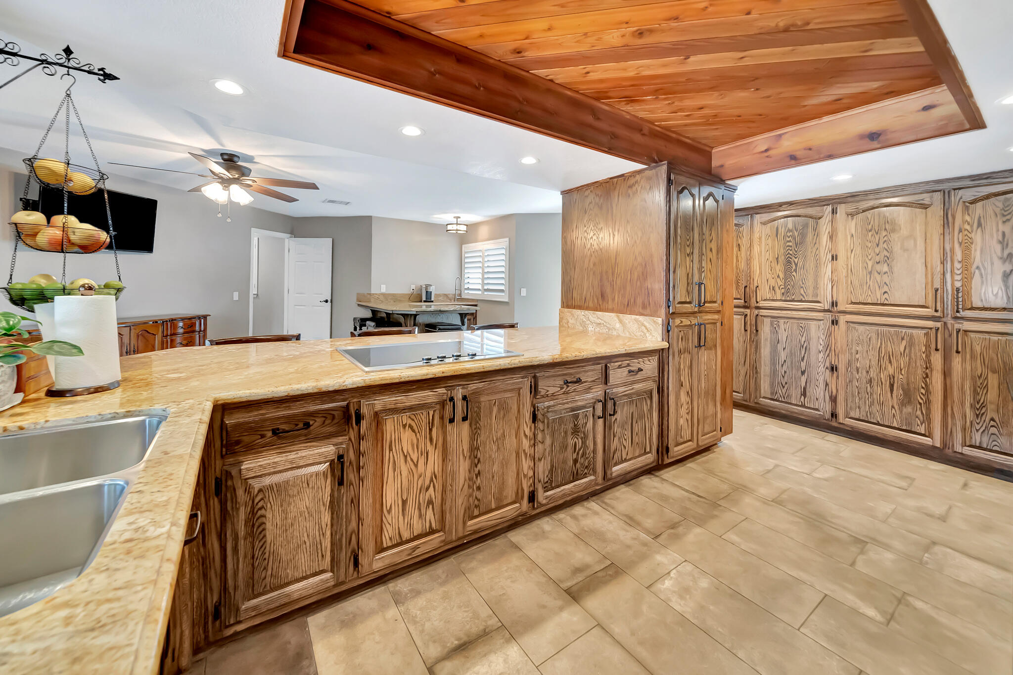 39844 Golfers Drive Palmdale, CA 93551 - Photo 25 of 87 a large kitchen with kitchen island granite countertop a sink cabinets and stainless steel appliances