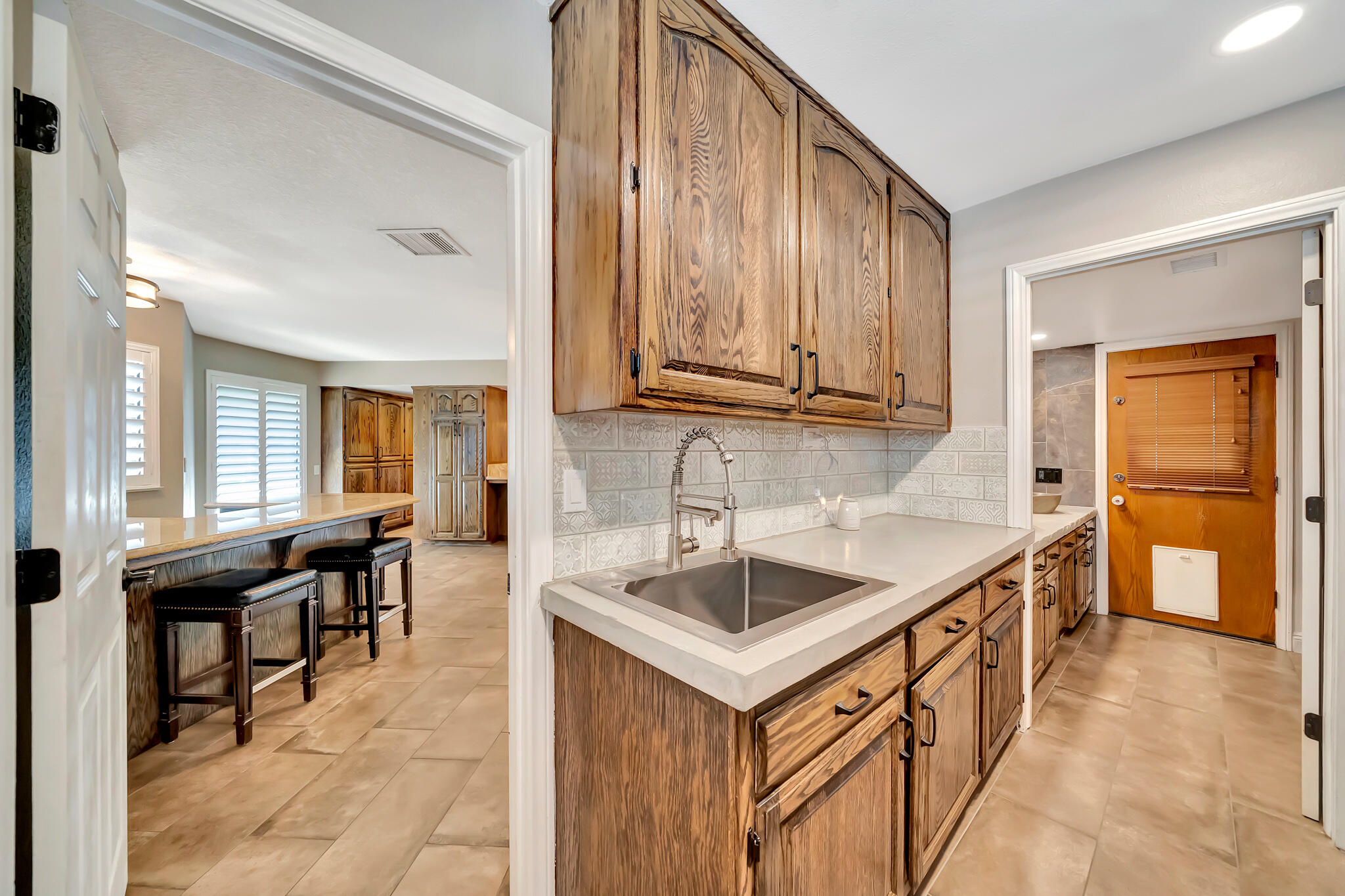 39844 Golfers Drive Palmdale, CA 93551 - Photo 29 of 87 a kitchen with sink cabinets and dining table