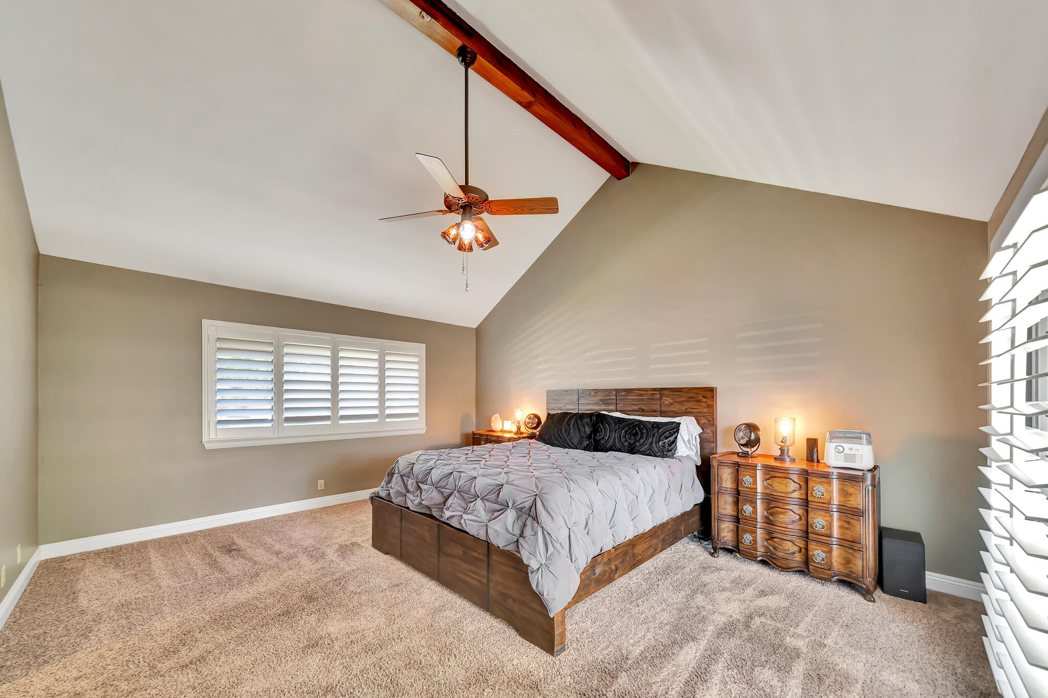 39844 Golfers Drive Palmdale, CA 93551 - Photo 39 of 87 a bedroom with a large bed and a chandelier