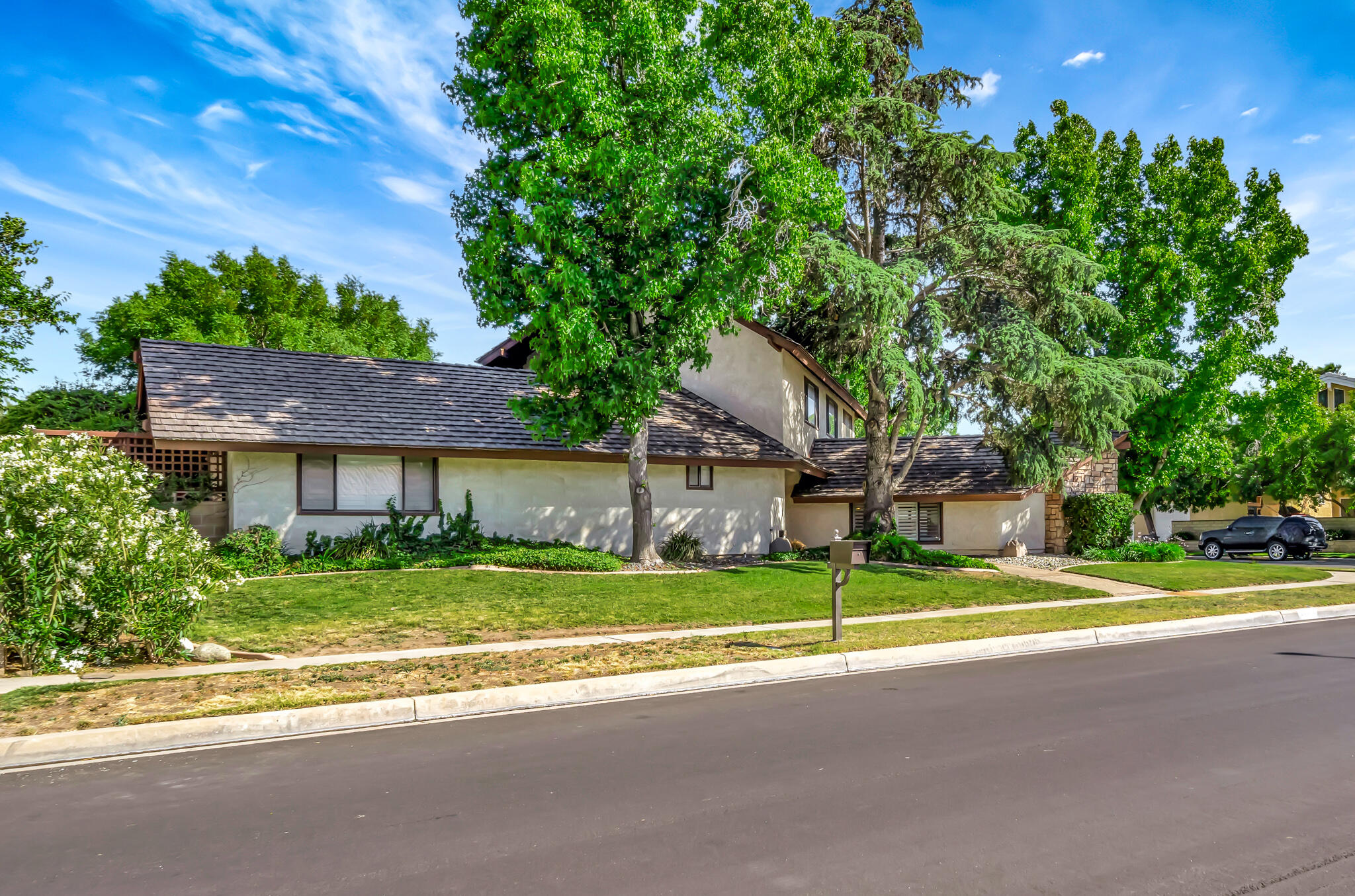 39844 Golfers Drive Palmdale, CA 93551 - Photo 4 of 87 a view of a house with a big yard and large trees