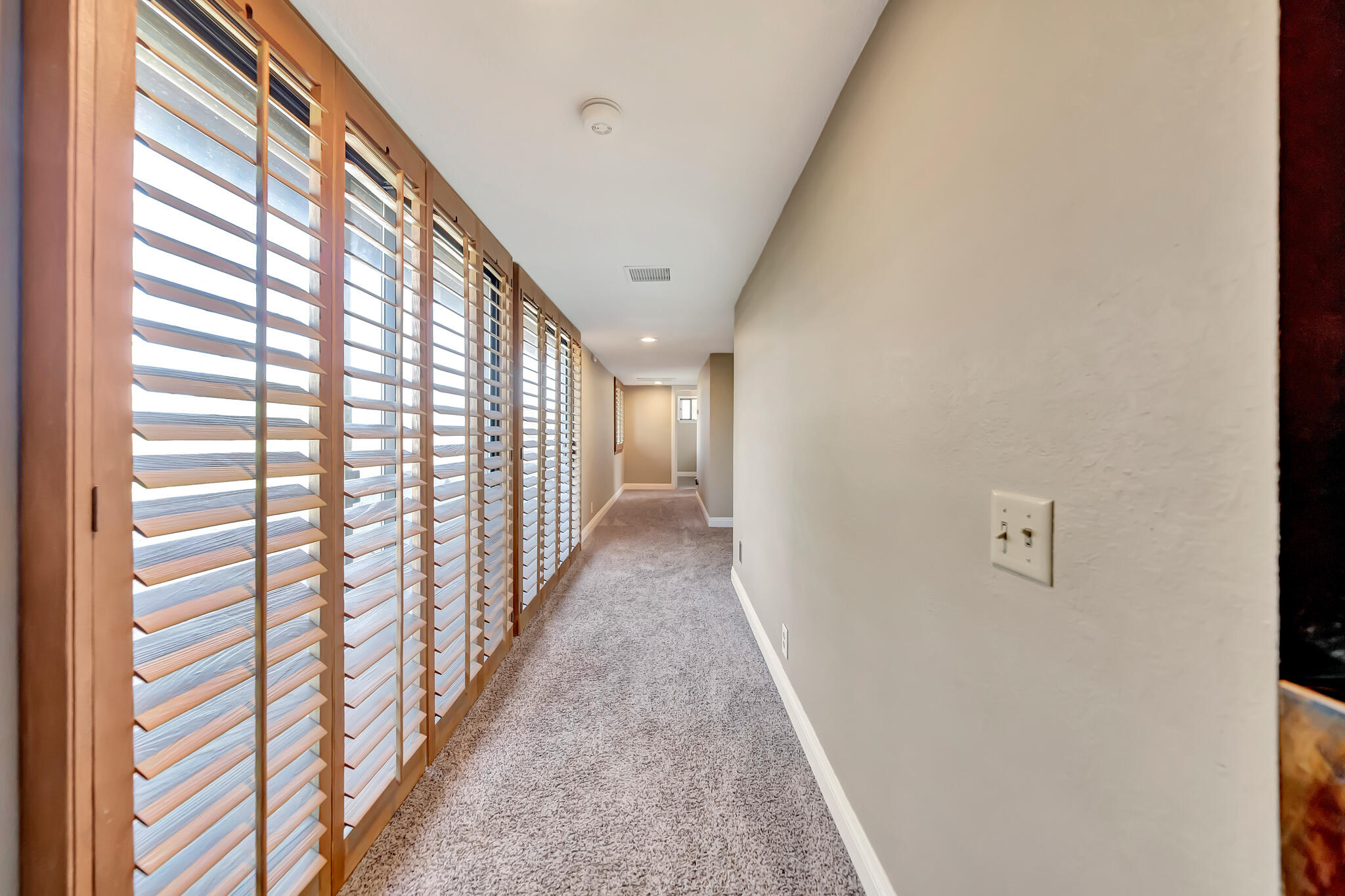 39844 Golfers Drive Palmdale, CA 93551 - Photo 42 of 87 a view of a hallway with wooden floor and stairs